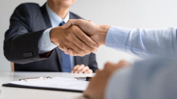 Man shaking hand with another person